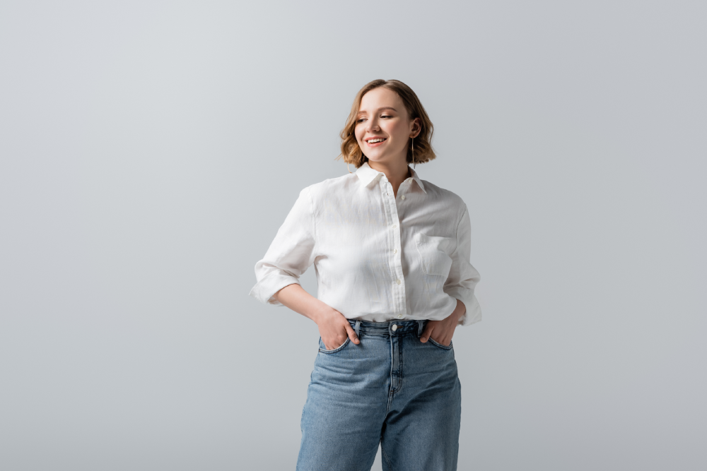 Smiling woman in casual outfit after medical weight loss.