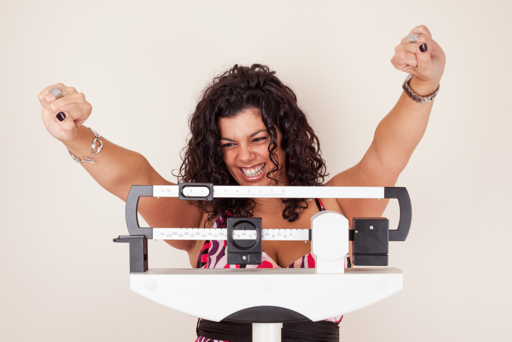 Happy woman celebrating weight loss success with Semaglutide.